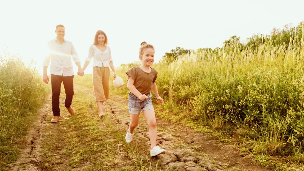 Happy child running with parents